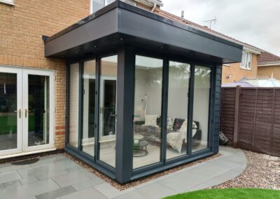 Modern orangery with closed bi-folds finished to paint