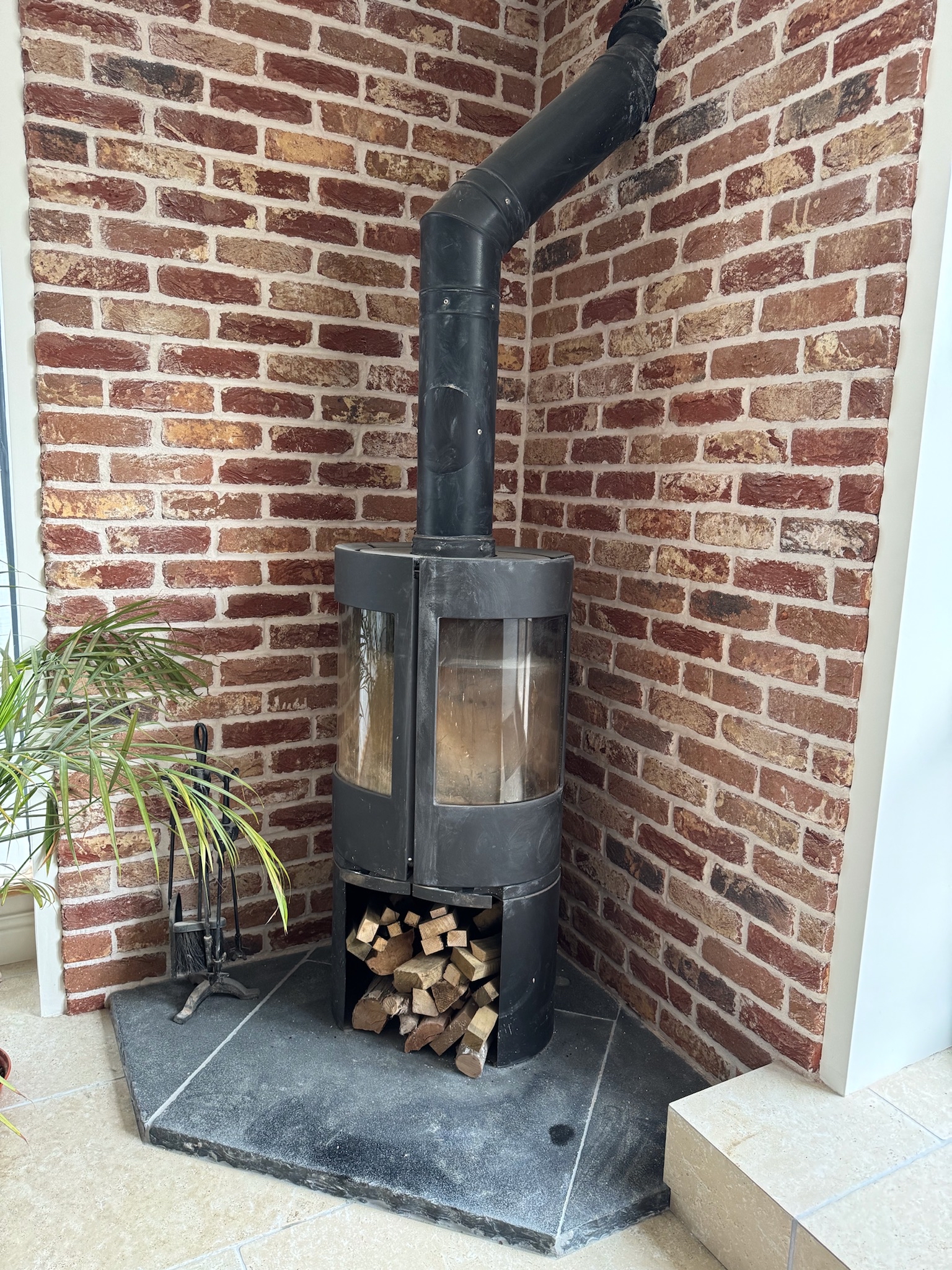 Log burner with brick and slate surround